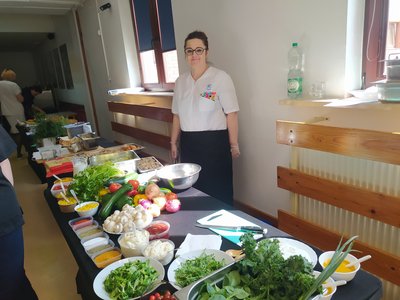 women behind table with many vegetables