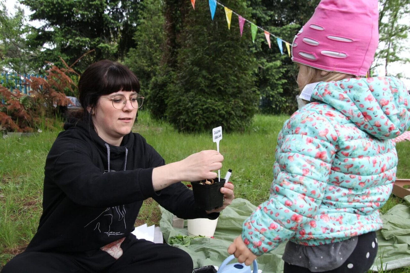 Explaining how to handle plants in the community garden.