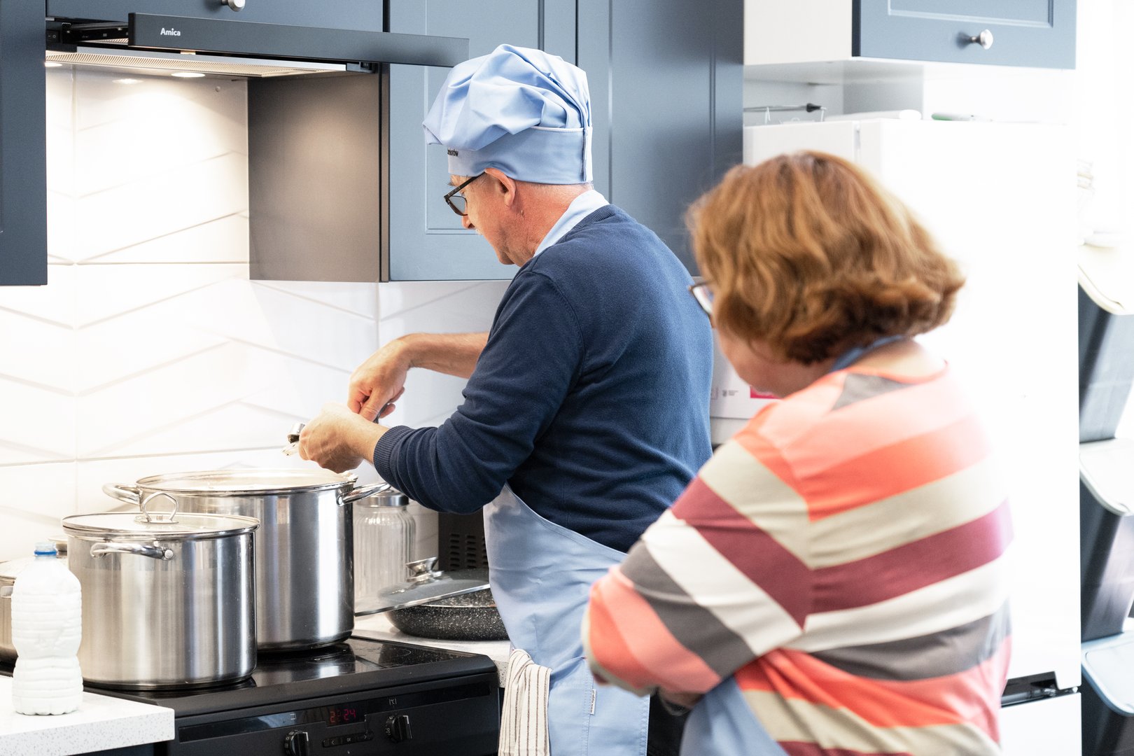 Cooking at the stove.